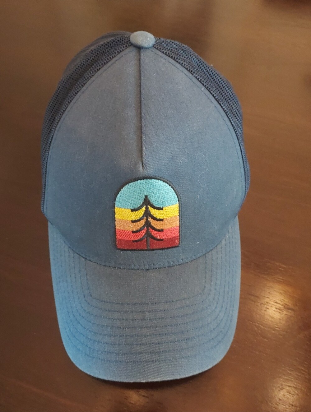 The Classic Navy Hat with Multicolor Sunset Pine Tree Patch. OS Adjustable.